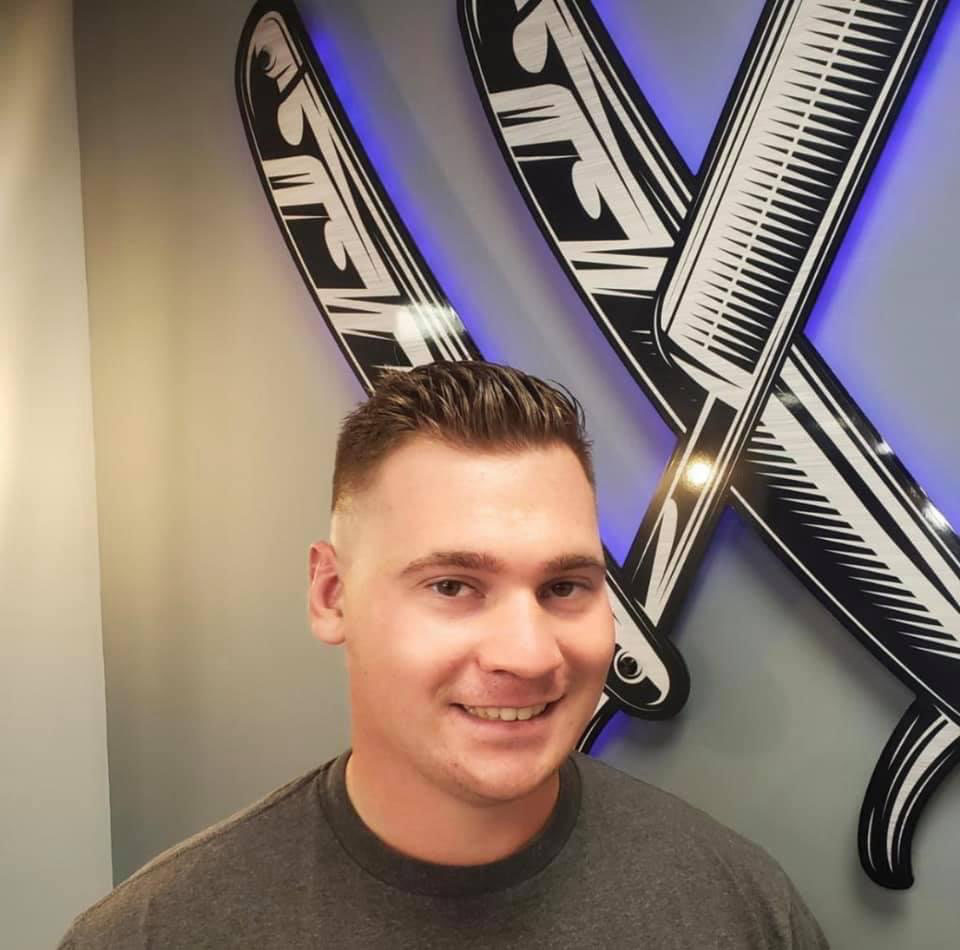 Modern quiff with tapered sides at Work of Art Barbershop