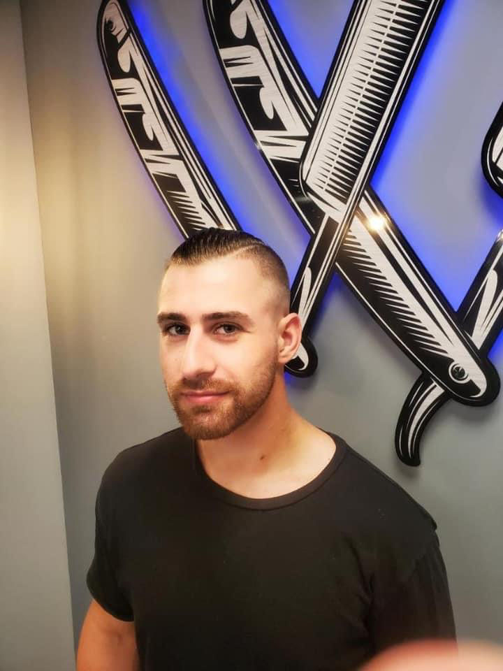 High and tight side part at Work of Art Barbershop