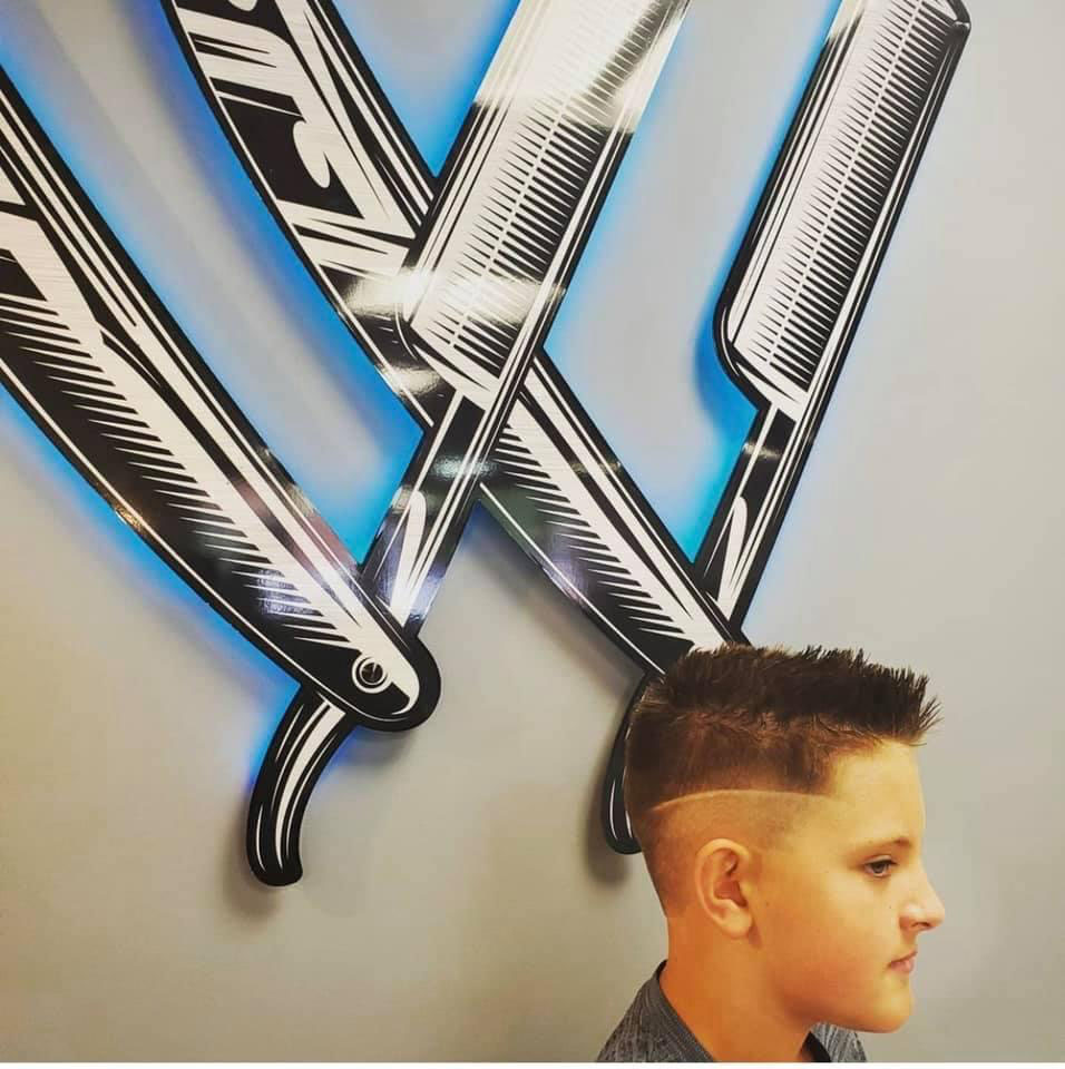 Kids' spiky fade with design line at Work of Art Barbershop